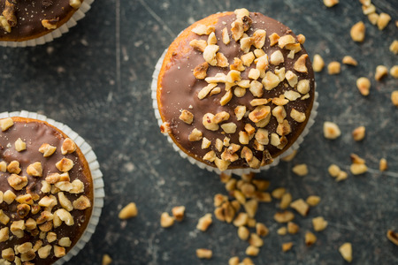 Sweet hazelnut muffins on old kitchen table. Top view.の写真素材