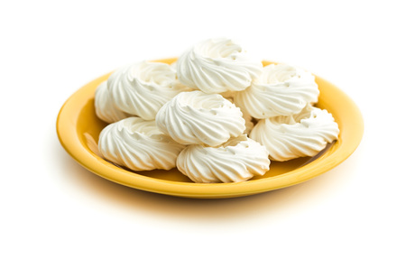 Sweet white meringue on plate isolated on white background.の写真素材