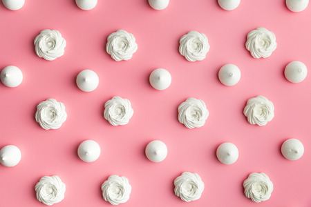 Sweet white meringue on pink background. Top view.の写真素材
