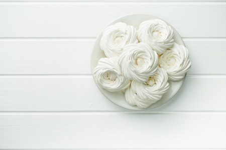 Sweet white meringue on white table. Top view.の写真素材