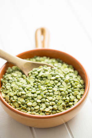 Green split peas in bowl on kitchen table.の写真素材