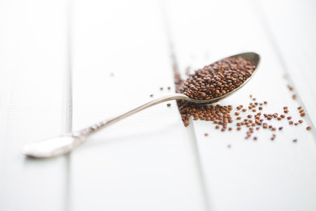Red quinoa seeds in spoon.の写真素材