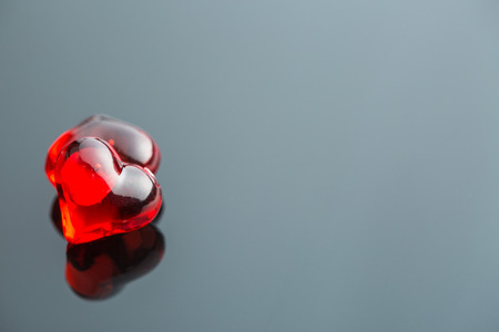 Two red hearts on black table.の写真素材