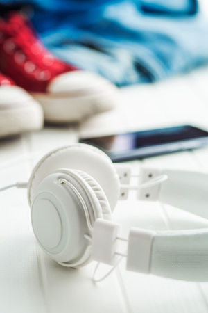 White vintage headphones connected to cellphone.の写真素材