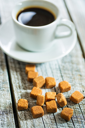 Brown sugar cubes with coffee cup.の写真素材