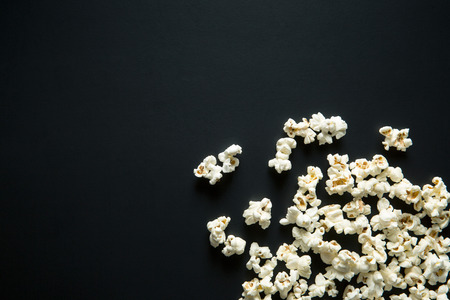 The salty popcorn on black background. Top view.の写真素材