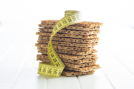 The healthy crispbread with measuring tape.の写真素材