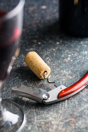 Cork and corkscrew on old table.の写真素材