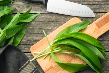 Ramson or wild garlic leaves on cutting board.の写真素材