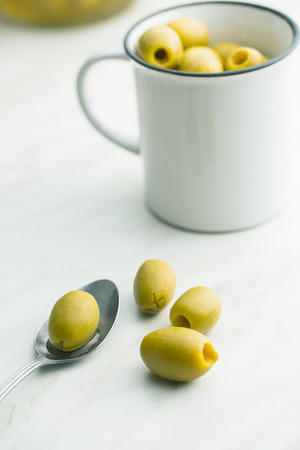 The green olives on kitchen table.の写真素材