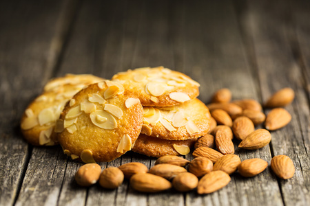 Sweet almond cookies on old wooden table. Black background.の写真素材