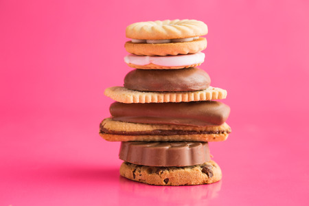 Various sweet biscuits on pink background.の写真素材