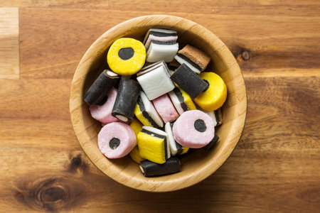Mixed liquorice candies in bowl. Top view.のeditorial素材