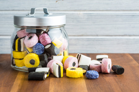 Mixed liquorice candies on wooden table.のeditorial素材