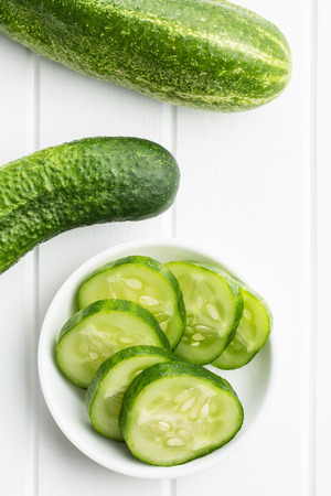 Sliced green cucumbers. Cucumbers in bowl. Top view.の写真素材