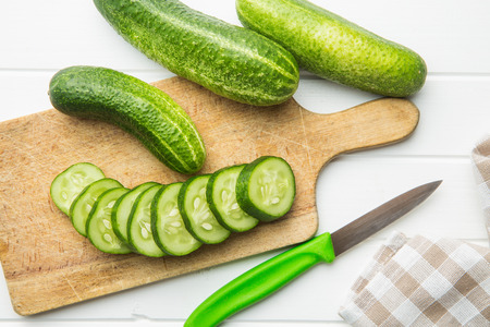 Sliced green cucumbers. Cucumbers on cutting board. Top view.の写真素材