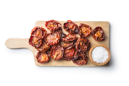 Tasty dried tomatoes and salt isolated on white background.の写真素材