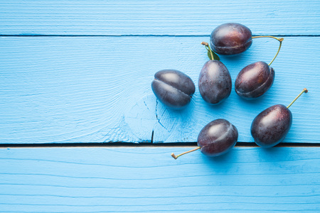 Fresh blue plums on blue table.の写真素材