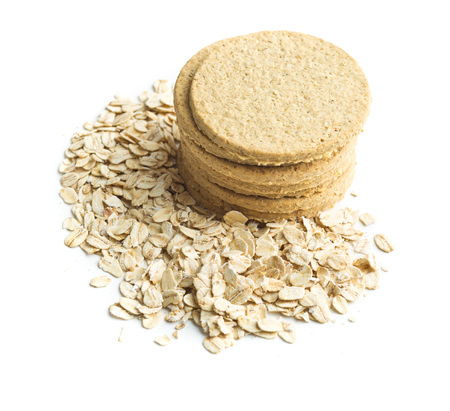Tasty oatmeal cookies and oat flakes isolated on white background.の写真素材