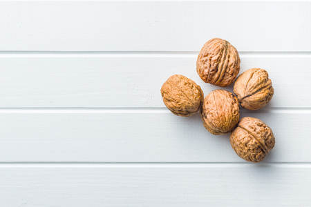 Tasty dried walnuts on white table. Top view.
