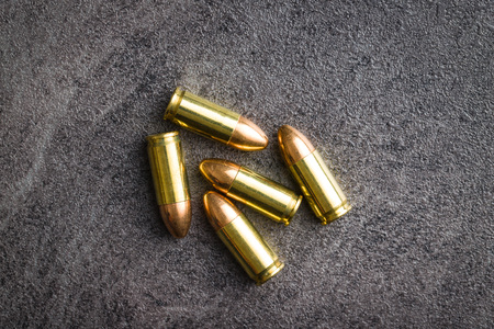 9mm pistol bullets on black table.の写真素材