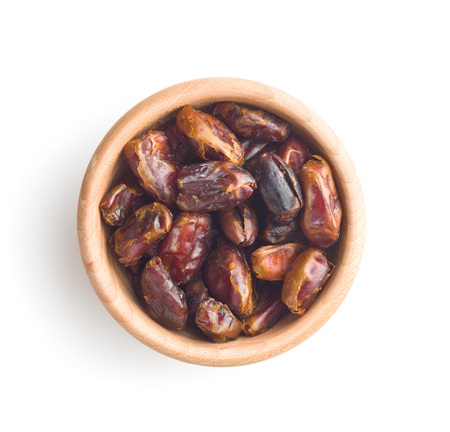 Sweet dates without stones in bowl isolated on white background.の写真素材