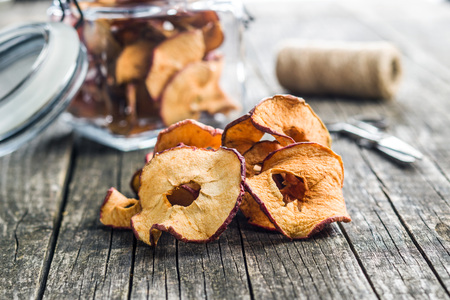 Tasty dried apple slices on old wooden table.の写真素材