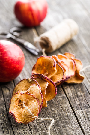 Tasty dried apple slices on old wooden table.の写真素材