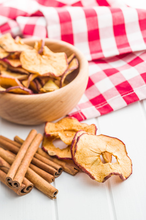 Dried apple slices and cinnamon on kitchen table.の写真素材