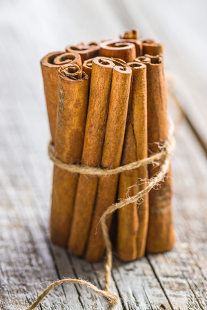 Cinnamon sticks spice on old table.の写真素材