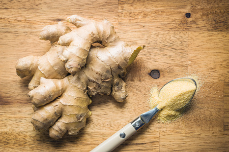 Dried and fresh ginger root on wooden table.の写真素材