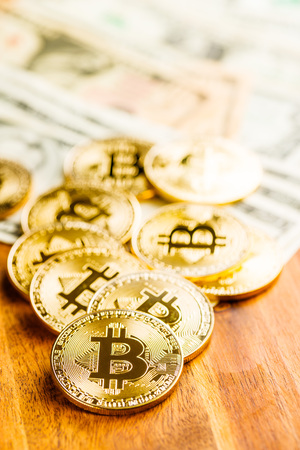Golden bitcoins. Cryptocurrency on wooden table.の写真素材