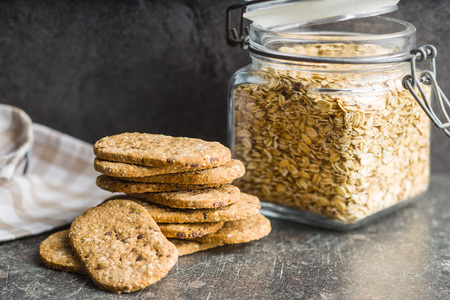 Tasty oatmeal cookies on old kitchen table.