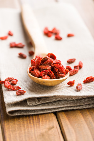 Dried goji berries in wooden spoon.の写真素材