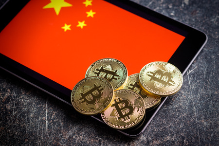 Golden bitcoins and chinese flag. Digital cryptocurrency.の写真素材