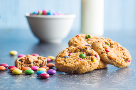 Sweet cookies with colorful candies on old kitchen table.の写真素材