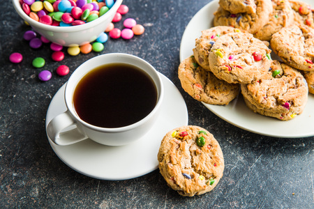 Sweet cookies with colorful candies and coffee cup.の写真素材