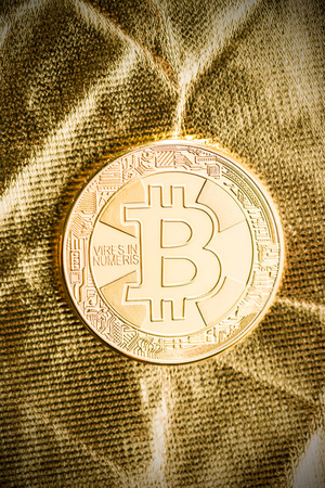 Golden bitcoins. Digital cryptocurrency on golden background.の写真素材
