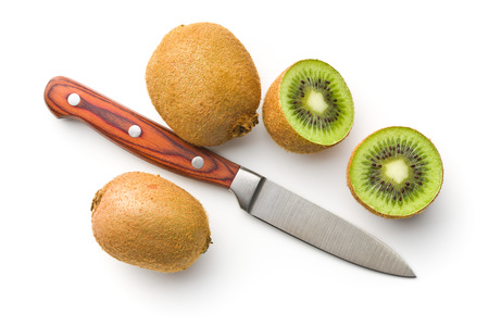 Halved kiwi fruit and knife isolated on white background.の写真素材