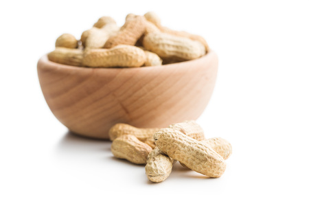 The unpeeled peanuts isolated on white background.