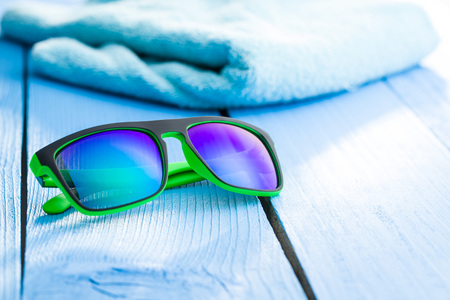 The modern sunglasses and blue towel on blue table.の写真素材