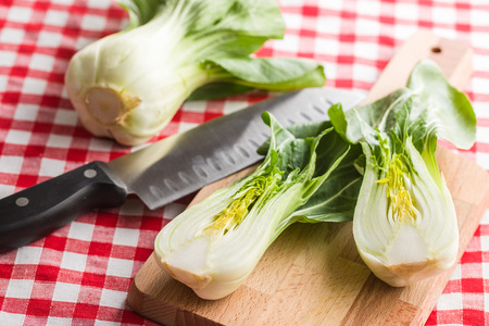 Halved pak choi cabbage on checkered napkin.の写真素材