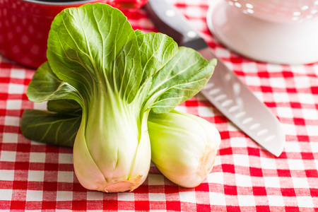 Fresh pak choi cabbage on checkered napkin.の写真素材