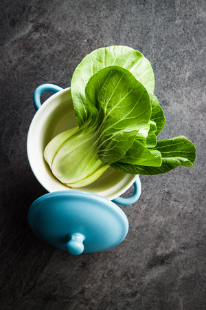 Fresh pak choi cabbage on black table.の写真素材