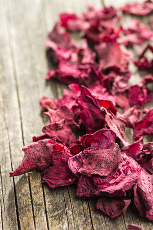 Dried beetroot chips on old wooden table.の写真素材