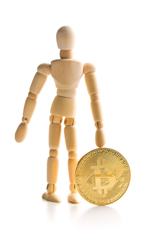 Bitcoin currency and wooden puppet isolated on white background.の写真素材
