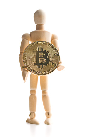 Bitcoin currency and wooden puppet isolated on white background.の写真素材