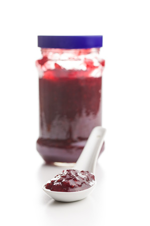 Tasty fruity jam in ceramic spoon isolated on white background.の写真素材