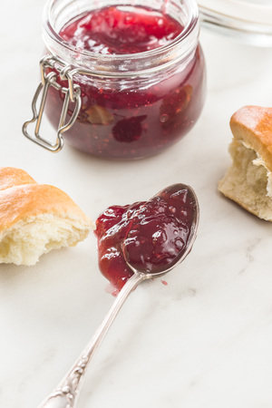 Tasty raspberry jam jelly in spoon.