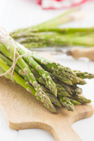 Fresh green asparagus on cutting board.の写真素材
